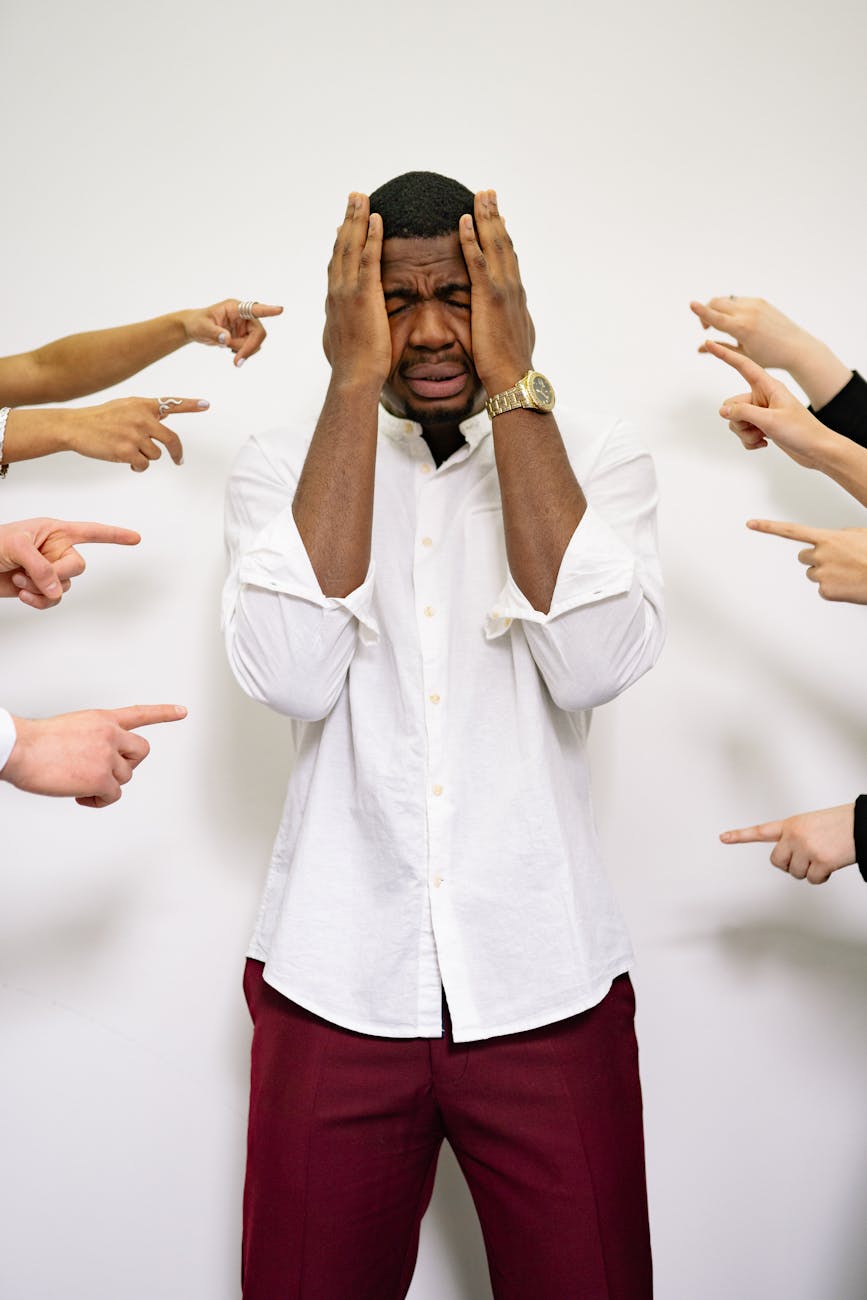 people pointing fingers at a stressed man